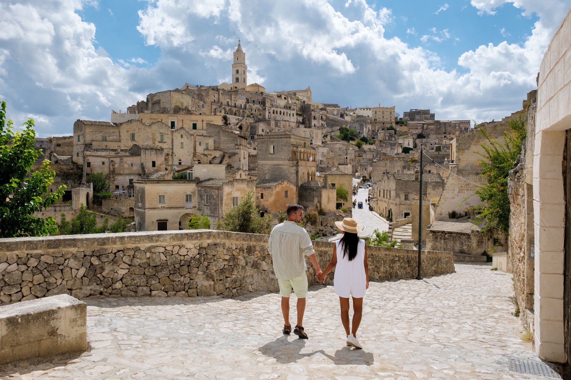 Exploring the enchanting streets of Matera, Puglia with a loved one under the dramatic sky
