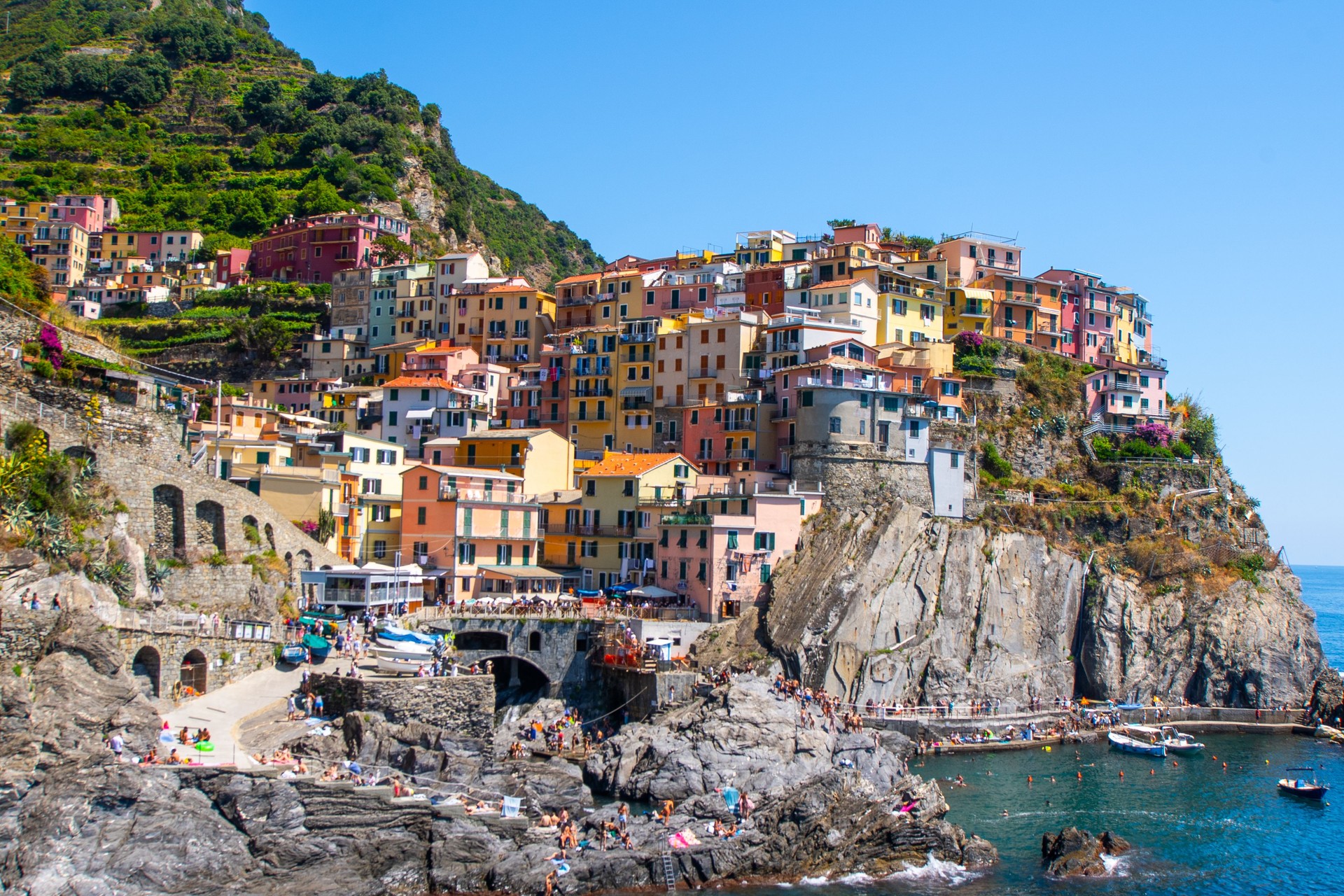 Multicolor houses on rock. Manarola Italian village Cinque Terre, Liguria, Italy. Summer sea